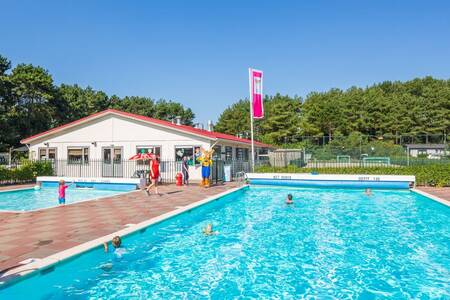 People swim in the outdoor pool of the Roompot Kustpark Egmond aan Zee holiday park