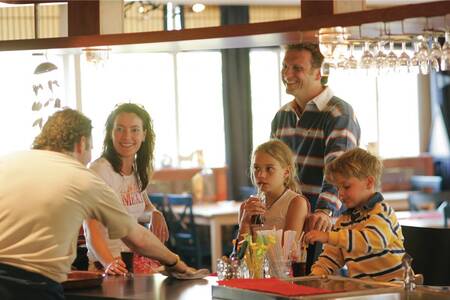 Family at the bar in a restaurant at the Roompot Kustpark Texel holiday park