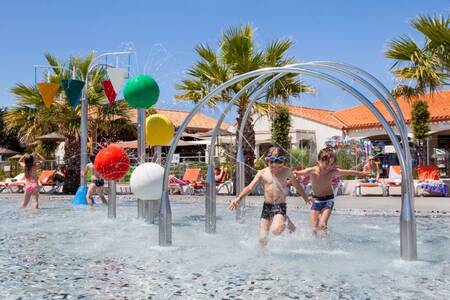 Children play in the water playground at the Roompot Le Littoral holiday park