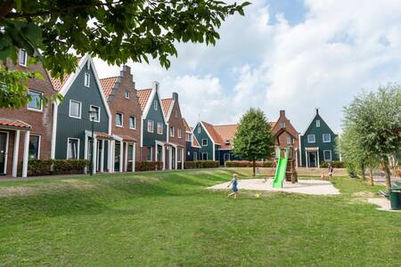 Children play in a playground between holiday homes at the Roompot Marinapark Volendam holiday park