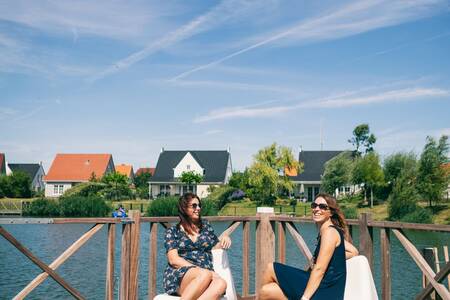 women on the terrace in front of holiday homes at the Roompot North Sea Résidence Cadzand-Bad