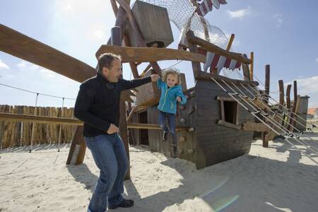 Child plays in the playground at the Roompot Noordzee holiday park Résidence Cadzand-Bad