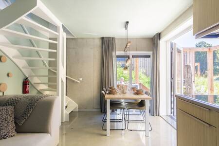 Living room with dining area and kitchen of a Duinlodge at Roompot North Sea Resort Vlissingen