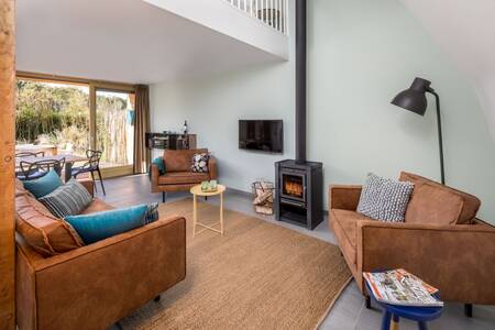 Living room with wood-burning stove in a luxury villa at the Roompot North Sea Resort Vlissingen