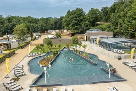 People swim in the outdoor pool of the Roompot Parc la Clusure holiday park