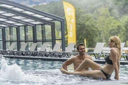 Couple in the swimming pool of the Roompot Parc la Clusure holiday park