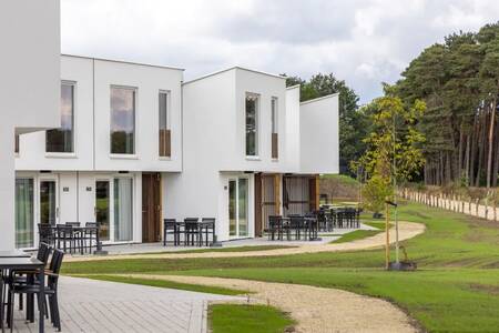 Terraces with garden furniture at holiday homes at the Roompot Park Eksel holiday park