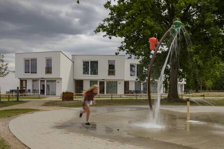 Child playing in the water playground at the Roompot Park Eksel holiday park