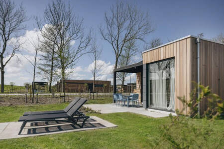 sun loungers in a garden of a holiday home at the Roompot Park Wijdenes holiday park