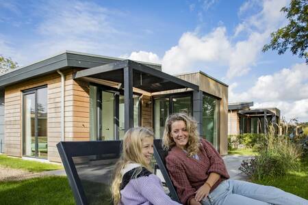 People on sun loungers in the garden of a holiday home at Holiday Park Roompot Park Wijdenes