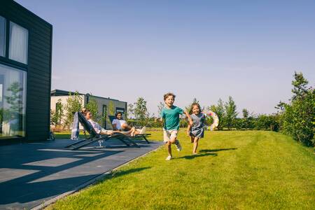 People in the garden of a holiday home at Holiday Park Roompot Park Zeedijk