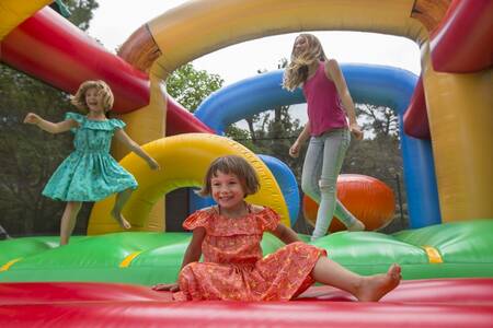 Children jump on the bouncy castle at the Roompot Plein Air des Chênes holiday park