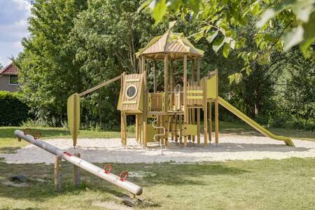 Playground with seesaw and climbing frame with slide at the Roompot Recreatiepark de Tolplas