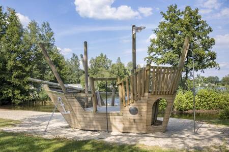 A wooden play ship in a playground at the Roompot Recreatiepark de Tolplas holiday park
