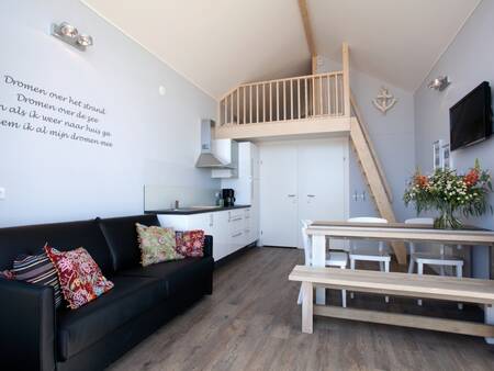 Living room with kitchen of a Beach House at Roompot Strandhuisjes Julianadorp