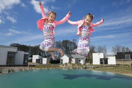 children jump on the air trampoline in a playground at Roompot Strandpark Duynhille