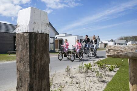 People cycle across the Roompot Strandpark Duynhille holiday park