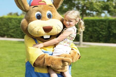 Girl is lifted by Koos rabbit at the Roompot De Katjeskelder holiday park