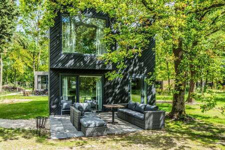 Detached villa with lounge set in the garden at Roompot Holiday Park Schaijk