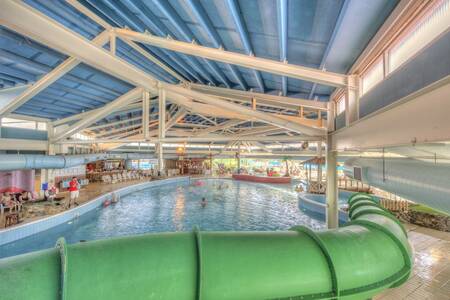 Long green slide in the indoor pool of Roompot Vakantiepark Weerterbergen