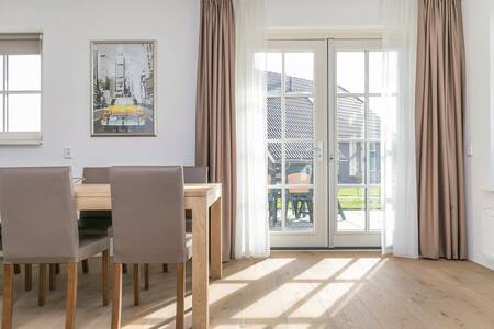 French doors in a living room of a holiday home at Roompot Villaparc Schoonhovenseland