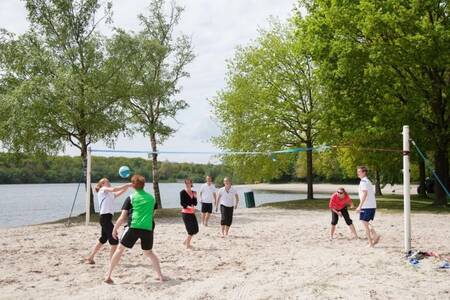 People play volleyball on the beach near Roompot Villaparc Schoonhovenseland