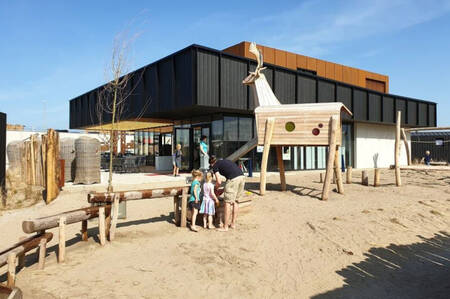 Children in the playground at the restaurant at the Roompot Zandvoort holiday park