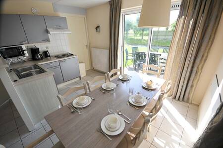 kitchen with table in a holiday home at the Roompot Zeeland Village holiday park