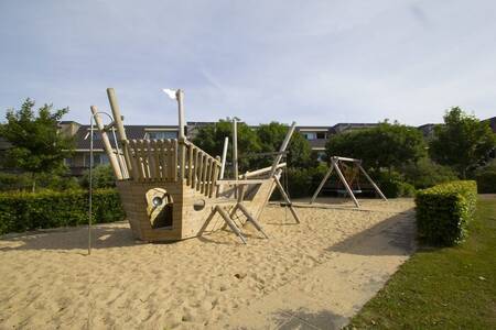 Play ship and swing in a playground at Résidence Terschelling