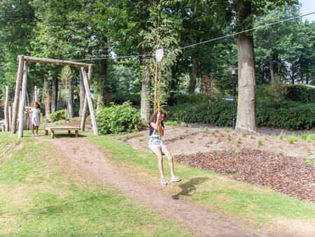 Girl on the cable car in a playground at the Topparken Landgoed de Scheleberg holiday park