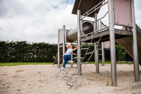 Child climbs on a playground in a playground at the Topparken Park Westerkogge holiday park