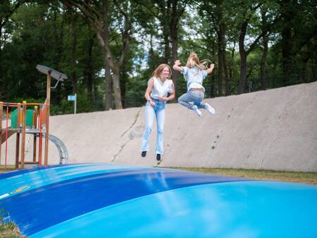 Children jump on the air trampoline in the playground of Topparken Recreatiepark de Wielerbaan
