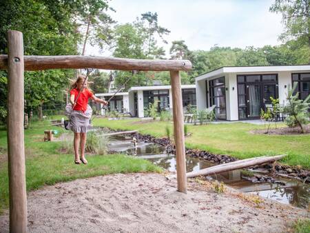 Girl on a swing in a playground at holiday park Topparken Recreatiepark Beekbergen