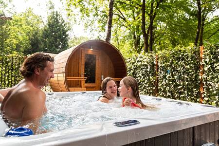 Family in the spa of a Wellness accommodation at the Topparken Recreatiepark Beekbergen holiday park