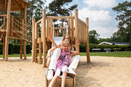 Children on the slide in a playground at the Topparken Recreatiepark 't Gelloo