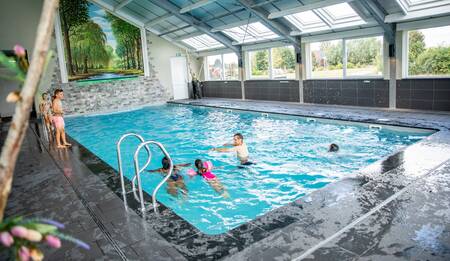 People swim in the indoor pool of the Topparken Residence Lichtenvoorde holiday park