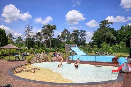 Children swim in the paddling pool outside at the Topparken Resort Veluwe holiday park