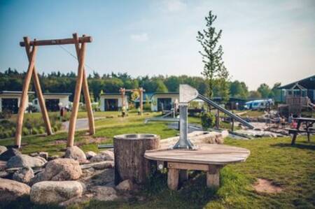 Various playground equipment in the playground of holiday park Ackersate