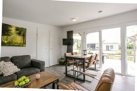 Living room and dining area of "Lodge Mistique" at De Lochemse Berg holiday park