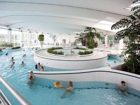 People swim in the indoor pool of the Aquacentre at Landal Village l'Eau d'Heure