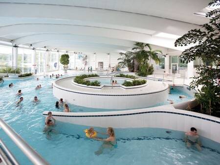 People swim in the indoor pool of the Aquacentre at Landal Village l'Eau d'Heure